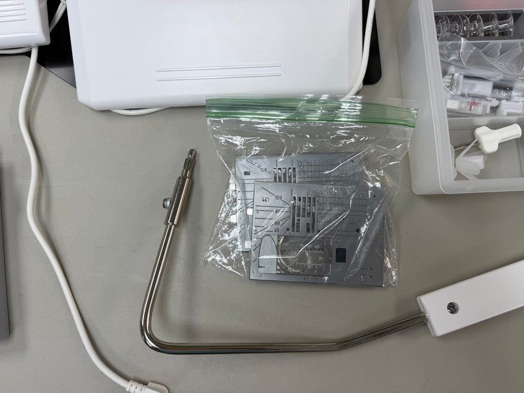 Knee lifter and extra needle plate
