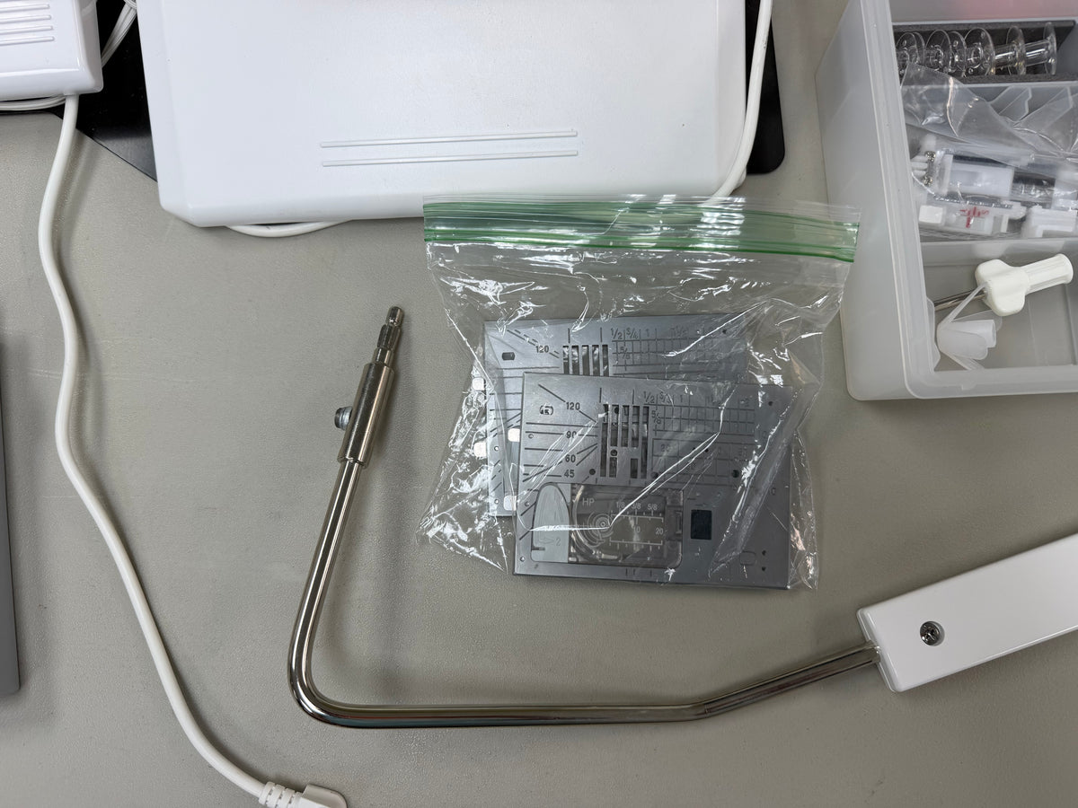 Knee lifter and extra needle plate