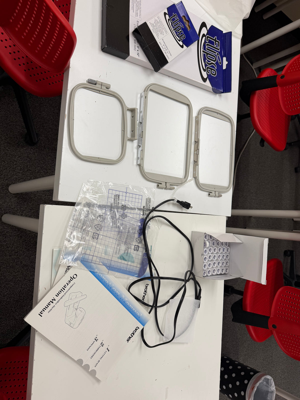 Brother PE770 included accessories: three embroidery hoops, Ellipse 5x12 and 1x2.5 hoops, grid sheets, bobbins, power cord and operation manual